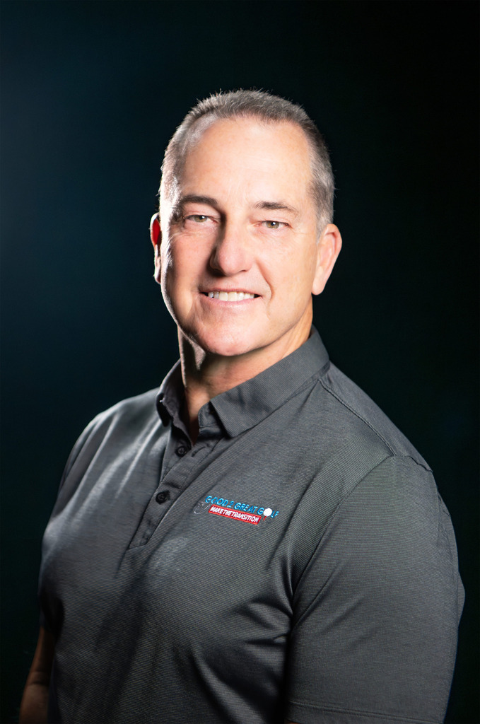 Professional headshot of man in gray polo shirt