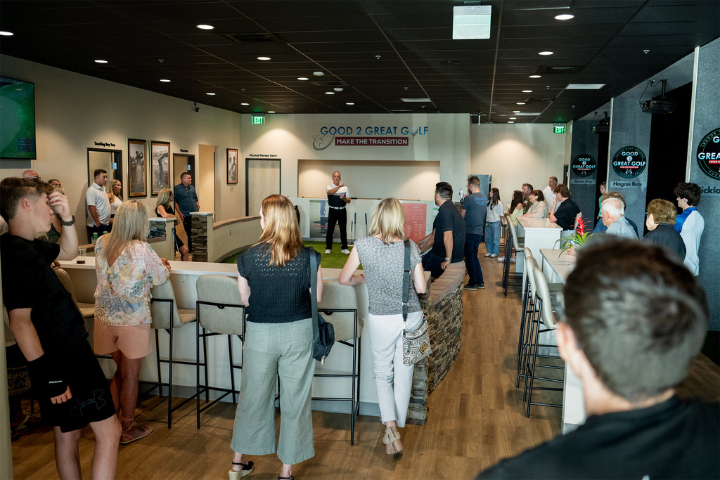 Golf instructor presenting to group indoors