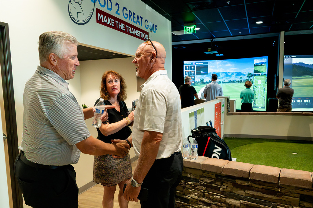 People socializing inside indoor golf simulator facility