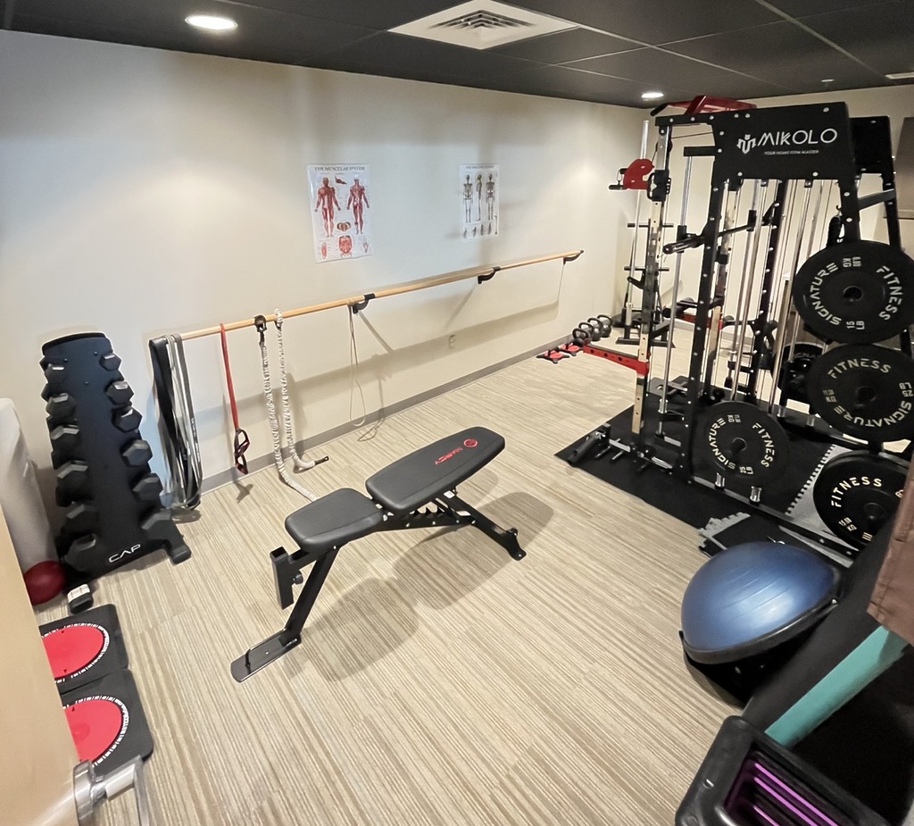 Fitness room with bench, weights, stability ball, and other equipment
